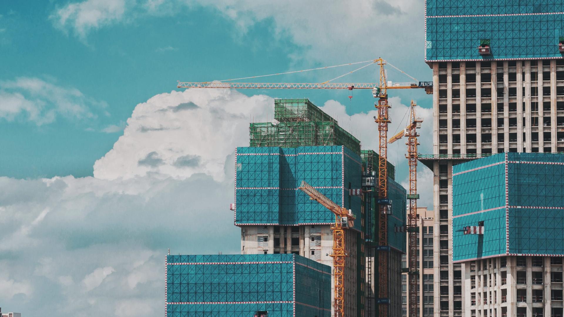Cranes and rising buildings against the Dubai sky